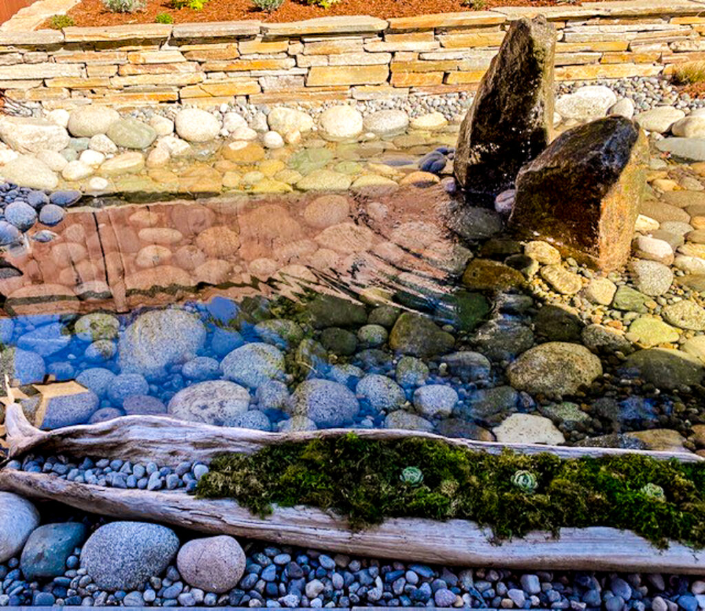 Landscaping environment designed recirculating rock bottom pond in Gig Harbor, WA