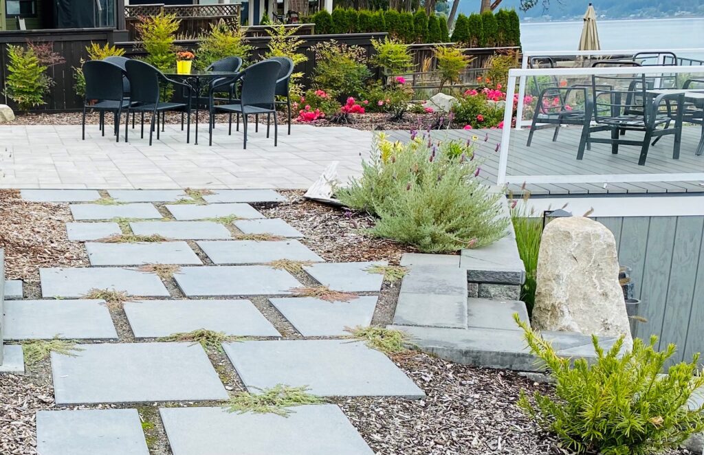 This Fox Island dining area boasts a concrete stepping path to paver design.